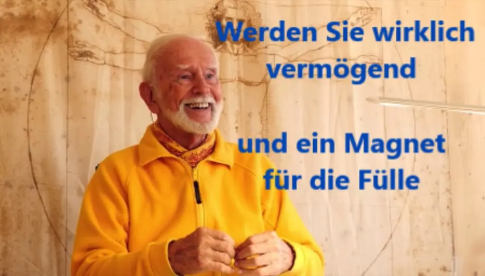Kurt Tepperwein in gelber Jacke vor einer Holzwand mit dem Schriftzug „Werden Sie wirklich vermögend und ein Magnet für die Fülle“
